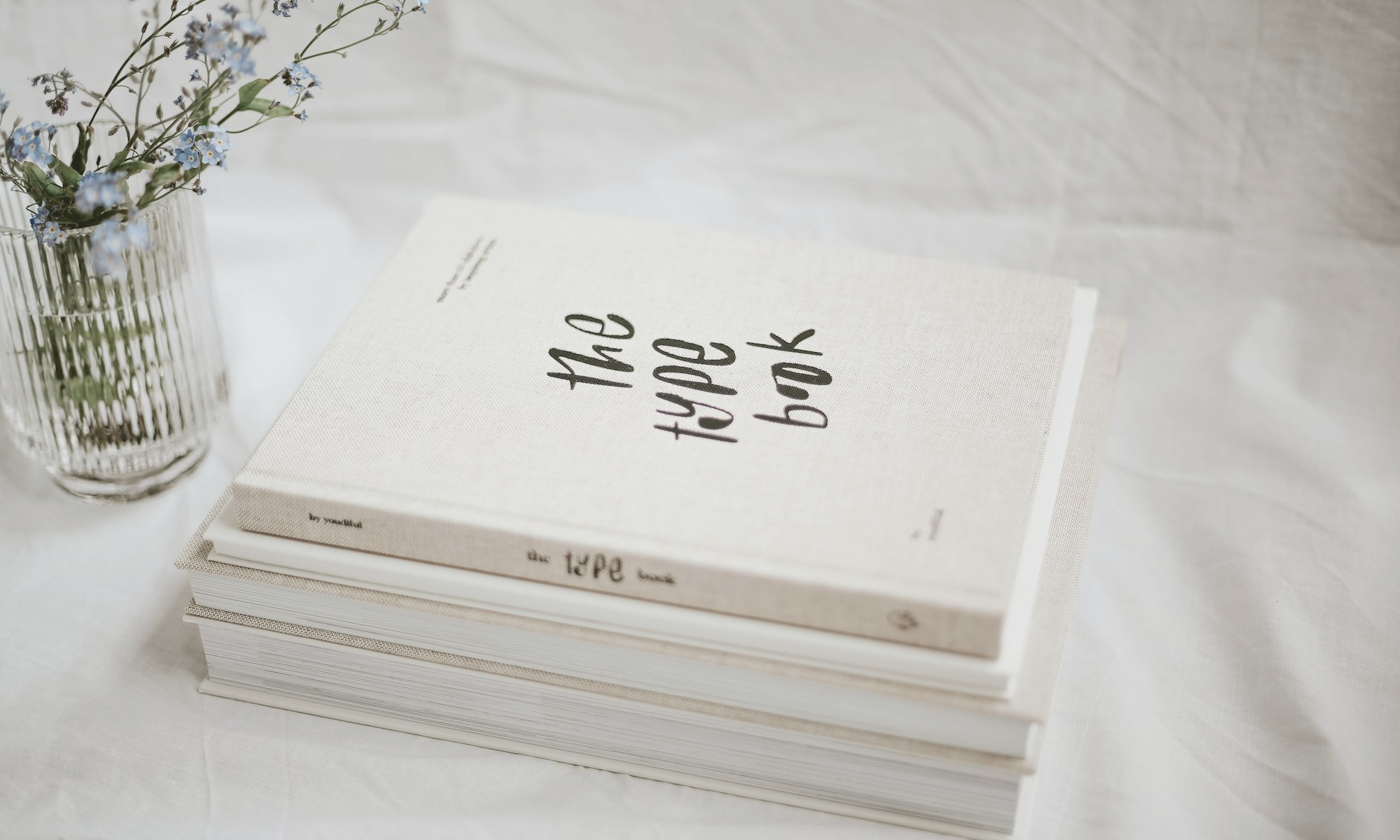 A notebook, pen and coffee on a work table