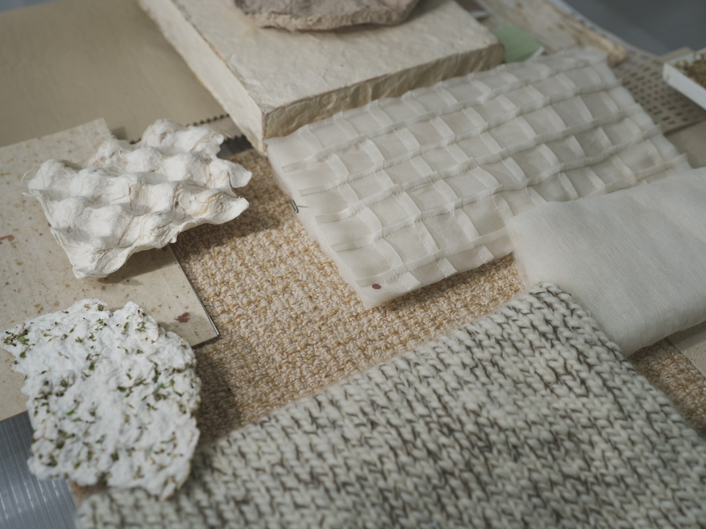 Fabric swatches, sketches and range plans on a work table