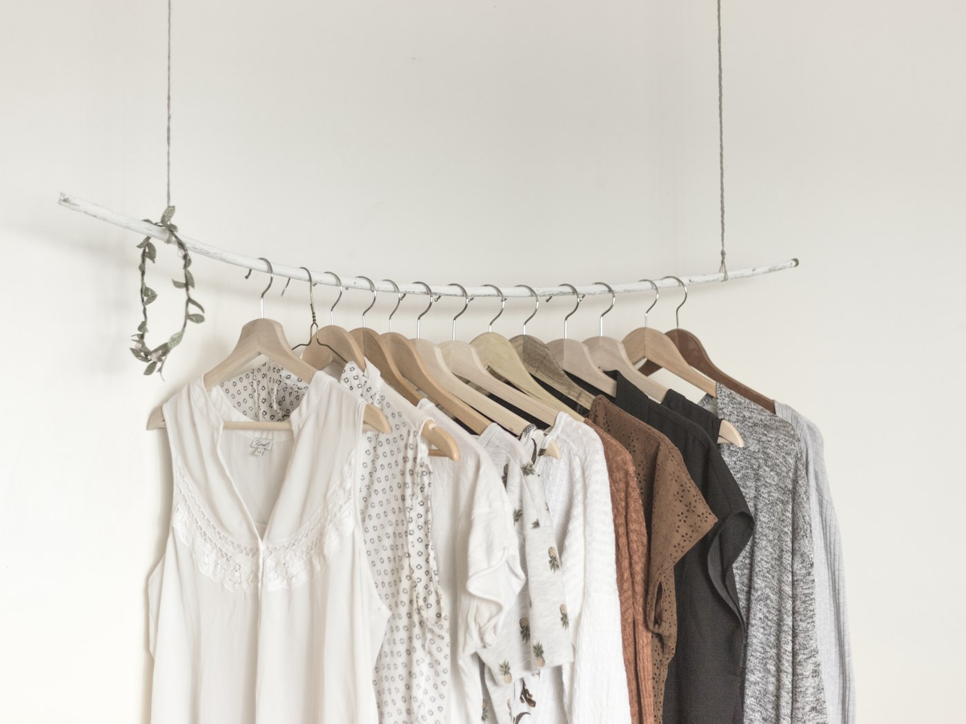 Bomo selecting garments from a rail with a client